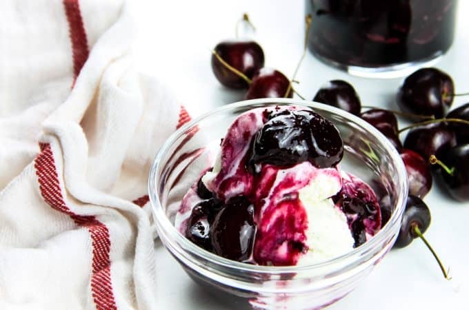 Easy Cherry Compote on ice cream in glass bowl