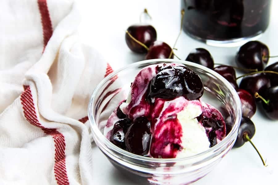 Easy Cherry Compote on ice cream in glass bowl