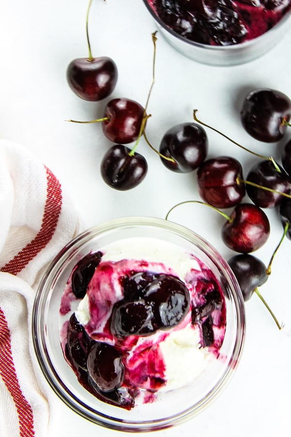 Easy Cherry Compote overhead view in glass bowl over ice cream