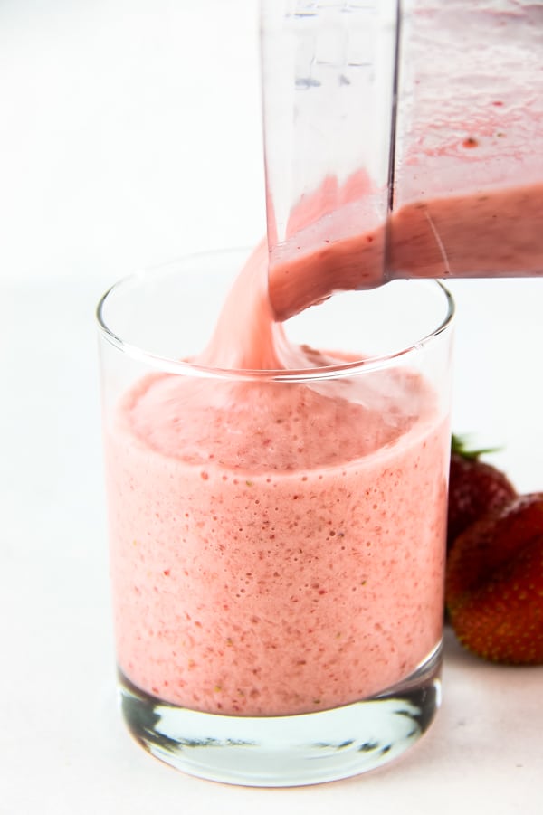 Strawberry Banana Smoothie being poured into glass