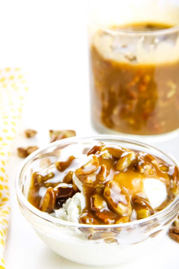 Butter Pecan Sauce in glass bowl with large cup of sauce in background