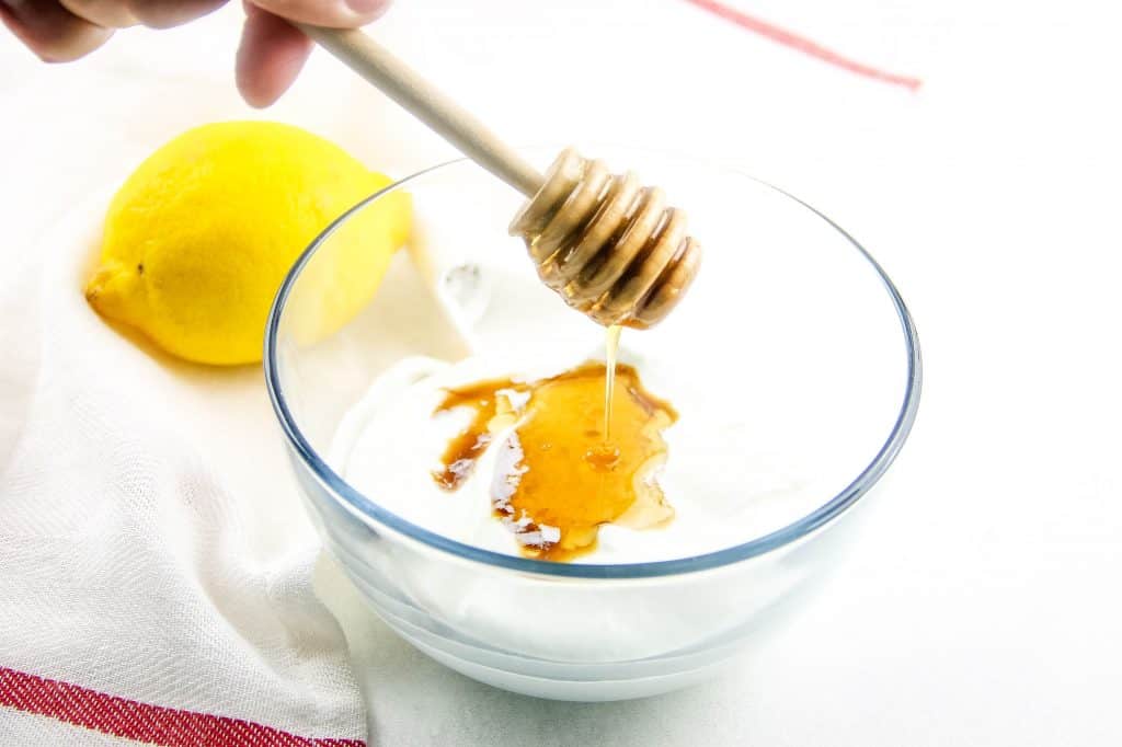 pouring honey into a bowl