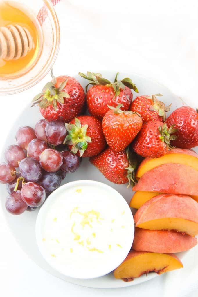 Honey Yogurt Dip overhead view in white bowl topped with lemon zest