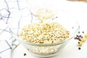 Chocolate Hazelnut Granola oil being poured in bowl