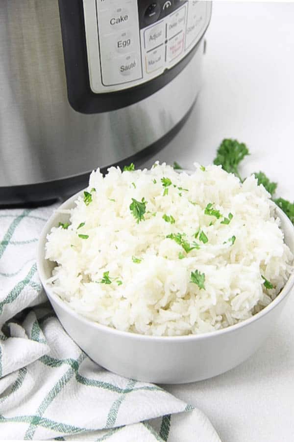 Instant Pot Basmati Rice in white bowl topped with parsley