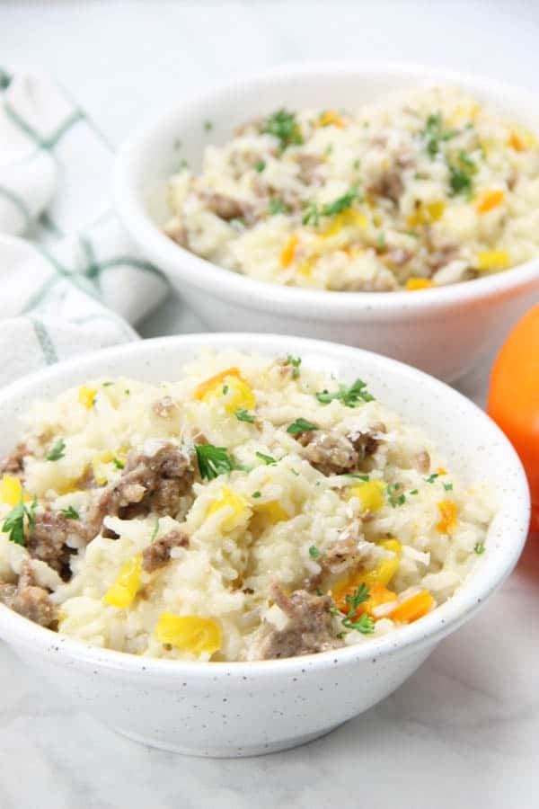 Instant Pot Sausage and Peppers Risotto in bowl topped with green parsley