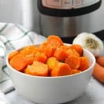 Instant Pot Carrots in gray bowl with green and white napkin