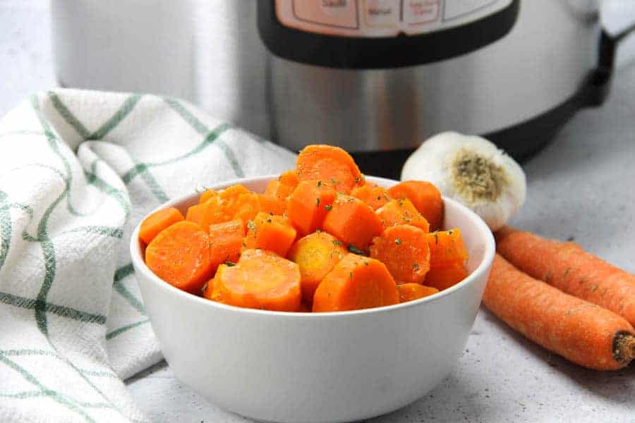 Instant Pot Carrots in gray bowl with green and white napkin