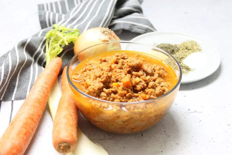 Instant Pot Turkey Ragu in glass bowl with ingredients in background