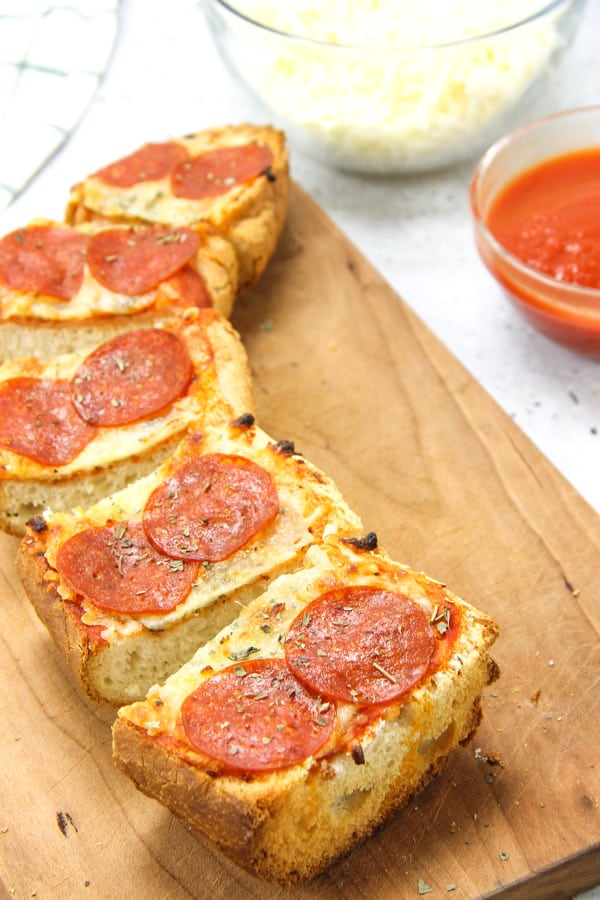 Pepperoni French Bread Pizza sliced on cutting board