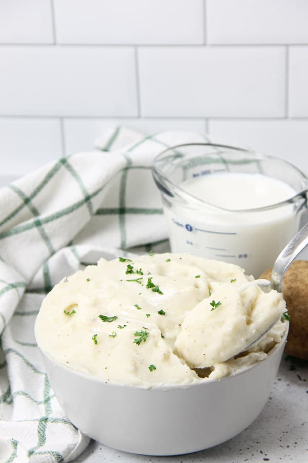 Pressure Cooker Potatoes with Gravy in bowl with spoon