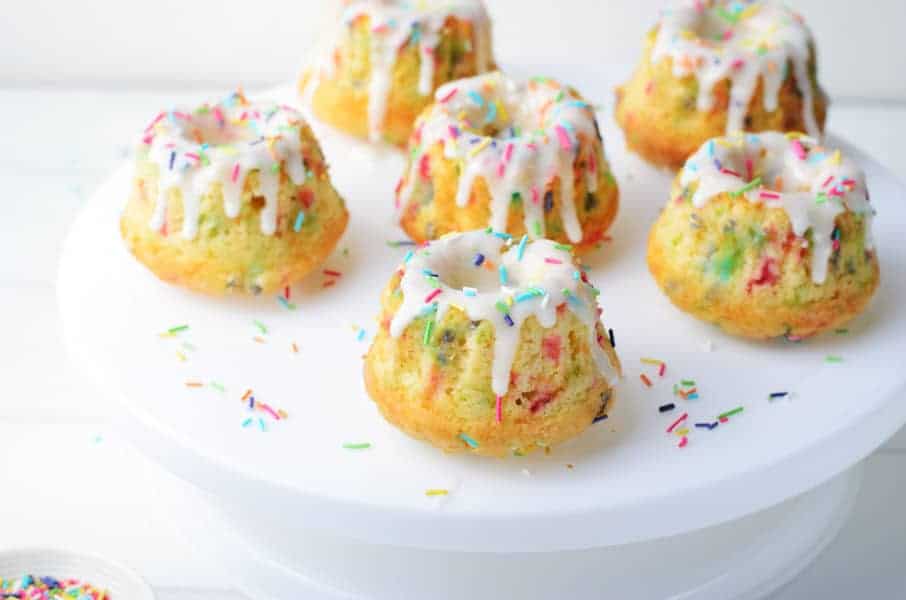 Funfetti Mini Bundt Cakes with 6 cakes on white cake plate