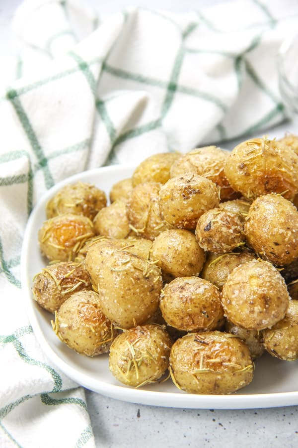 Roasted Rosemary Potatoes on white plate with green and white napkin