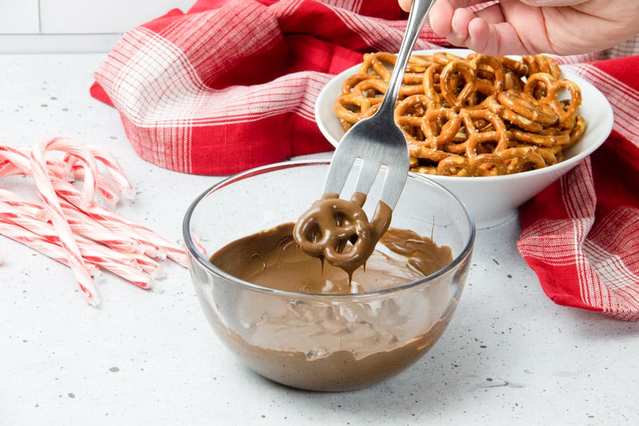 Pretzel dipped in chocolate in glass bowl