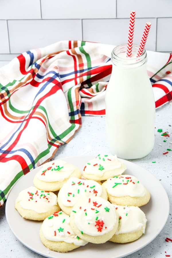 Soft Sugar Cookies on white plate with milk in a jug