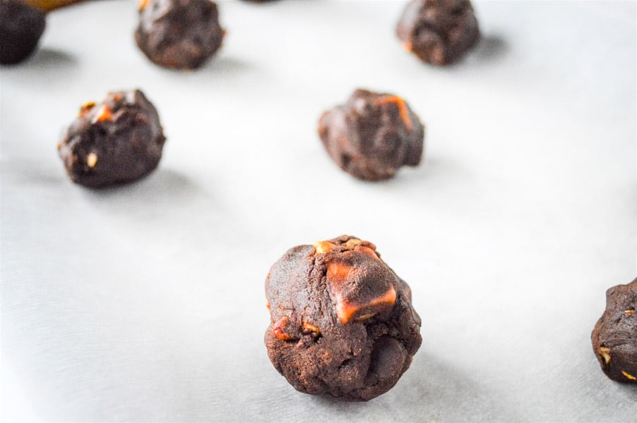 Chocolate Turtle Cookies in balls uncooked on baking sheet