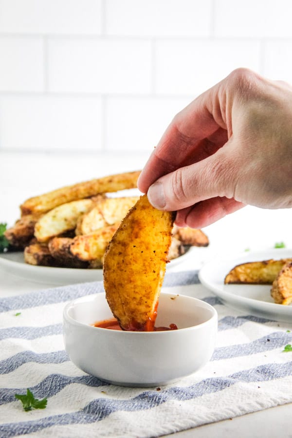 potatoes dipped into ketchup