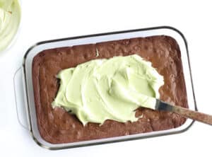 cooked brownies with frosting on top.