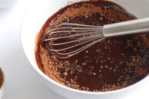 melted chocolate in bowl with cocoa powder.