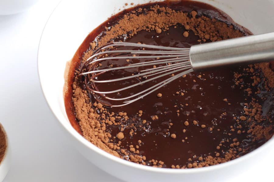 melted chocolate in bowl with cocoa powder.