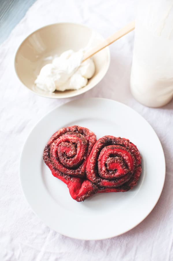 Red Velvet Cinnamon Rolls on plate with no frosting