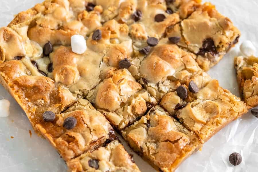 S'mores Blondies cut into pieces on parchment paper.