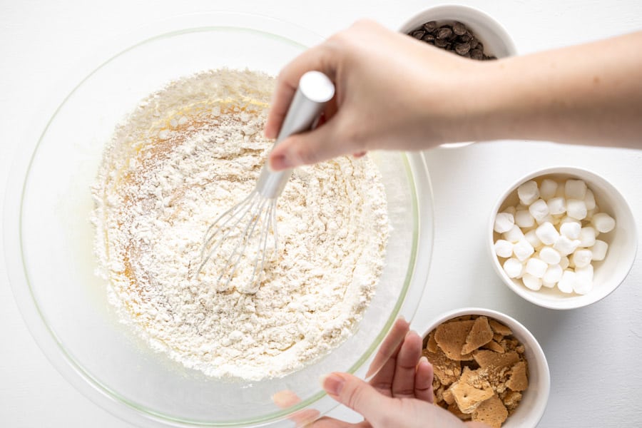 whisking flour in glass bowl.