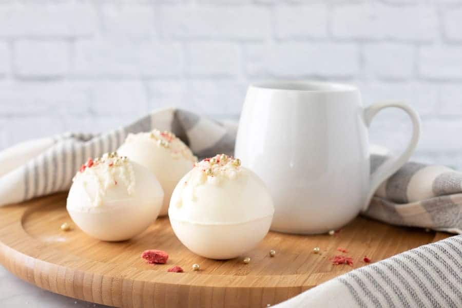 Strawberry Hot Cocoa Bombs on brown board