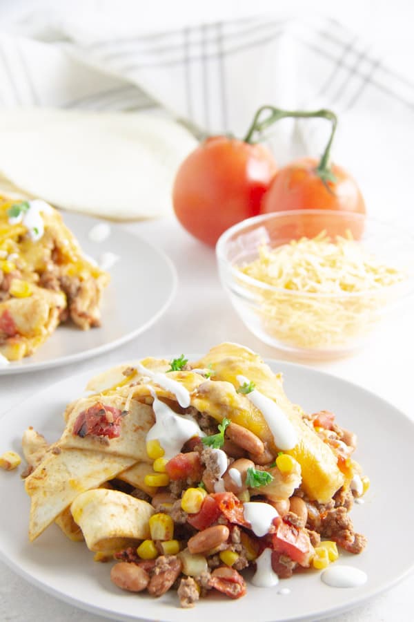 taco skillet on plate with sour cream on top.