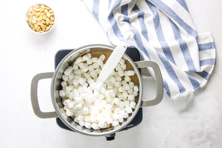 adding in marshmallows to pan