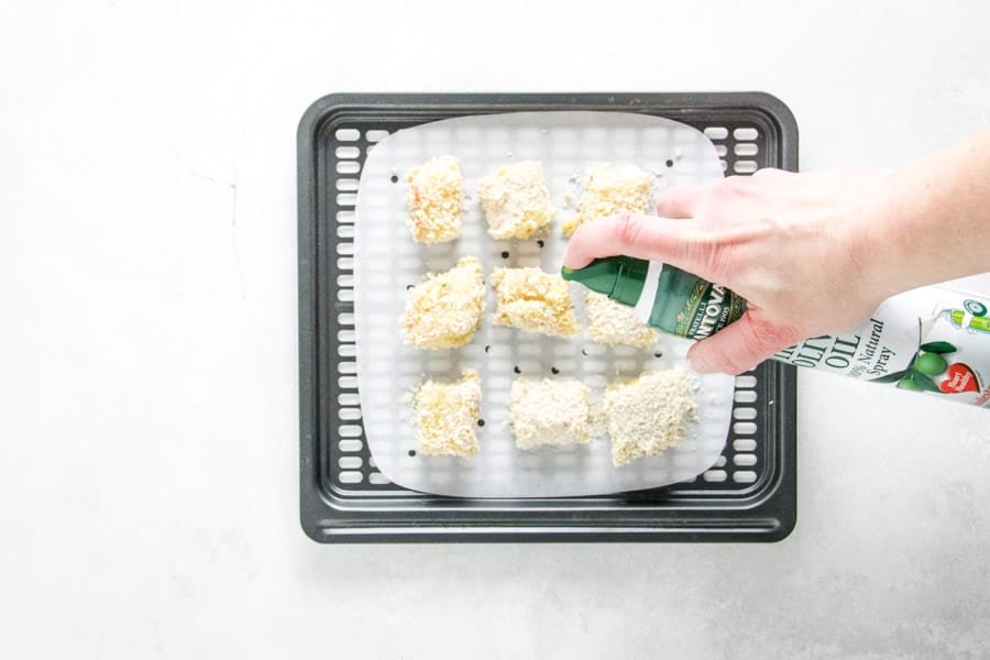 spraying nuggets with olive oil.