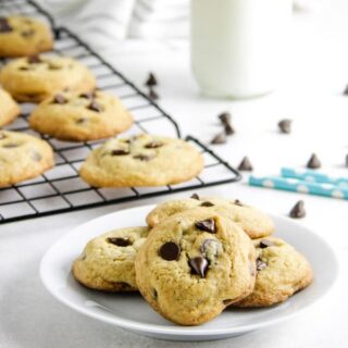 cookies on plate with chocolate chips in background.