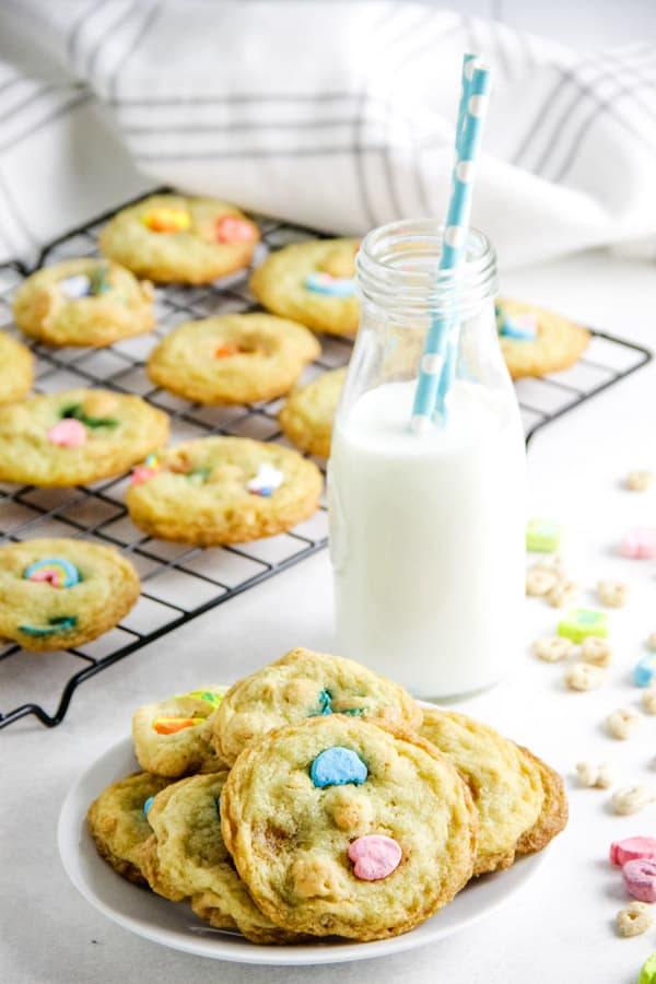 Lucky Sugar Cookies are a fun treat for the kids! I take my basic sugar cookie recipe and add Lucky Charms cereal to it! Lucky Sugar Cookies on small white plate.