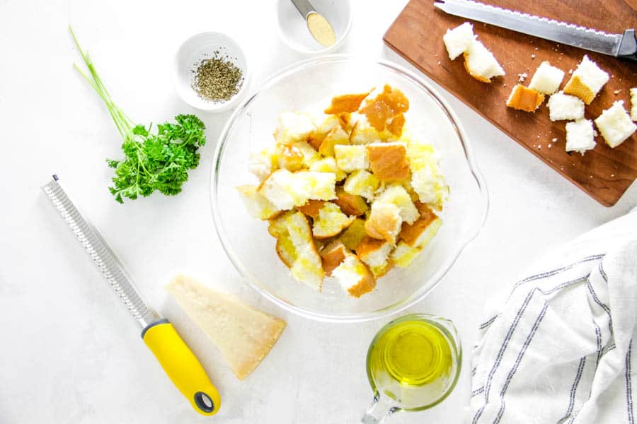 cubed bread topped with olive oil.