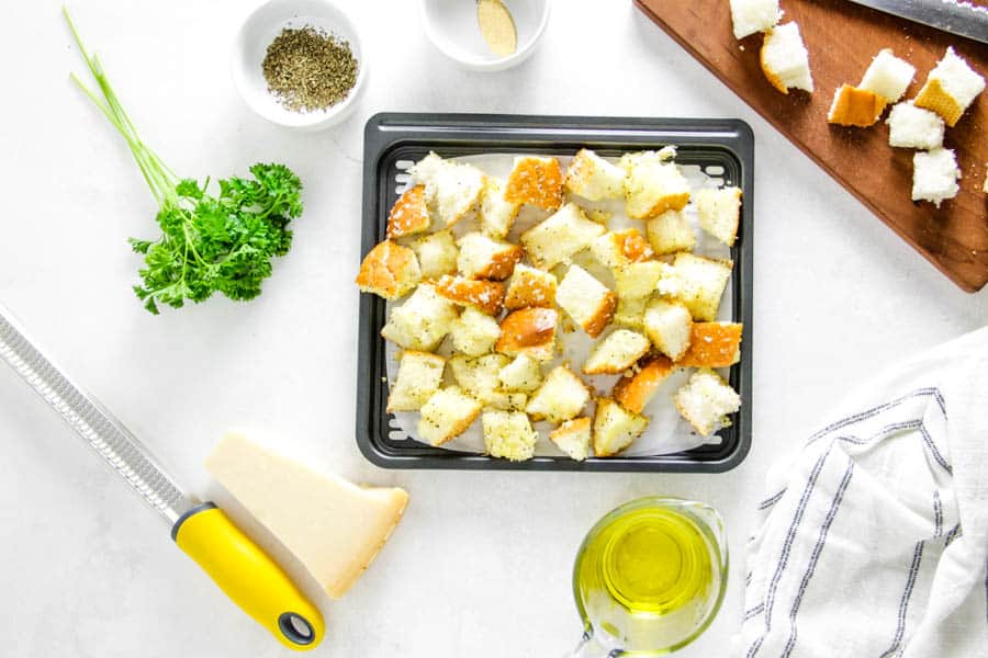 croutons on air fryer tray.