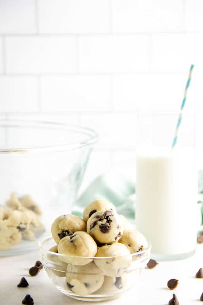 Cookie Dough Bites stacked in glass bowl.