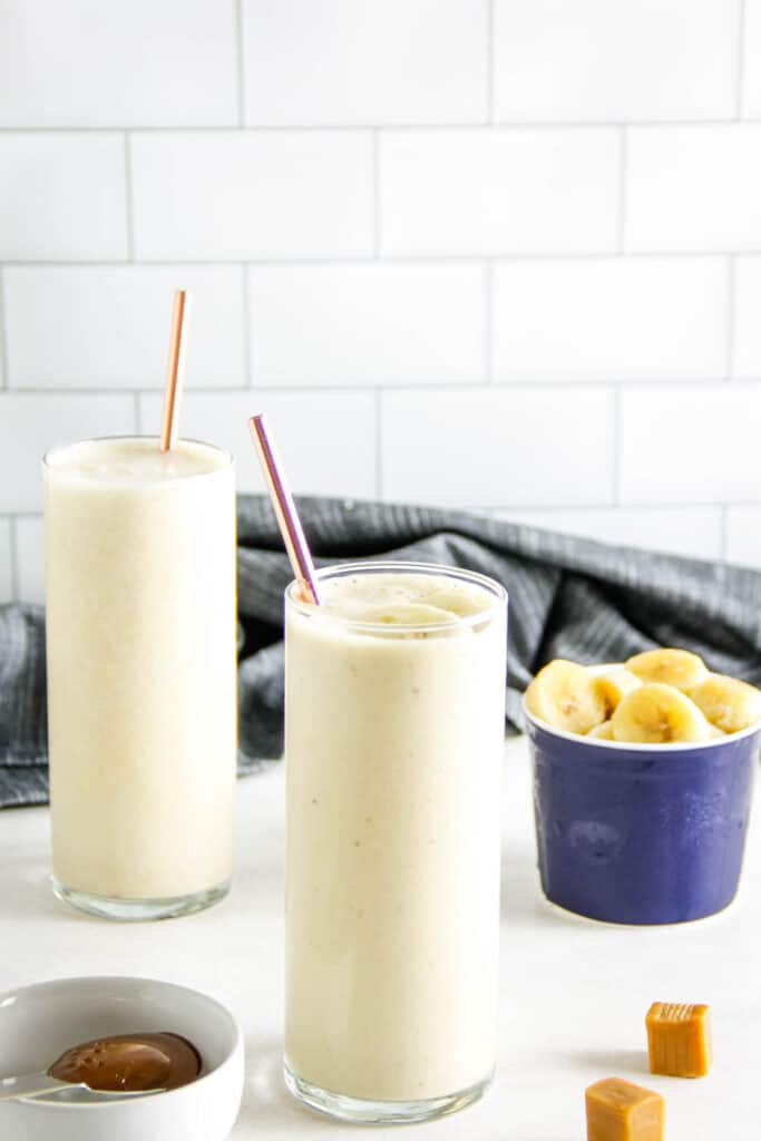 smoothie in glass with straw on white background.