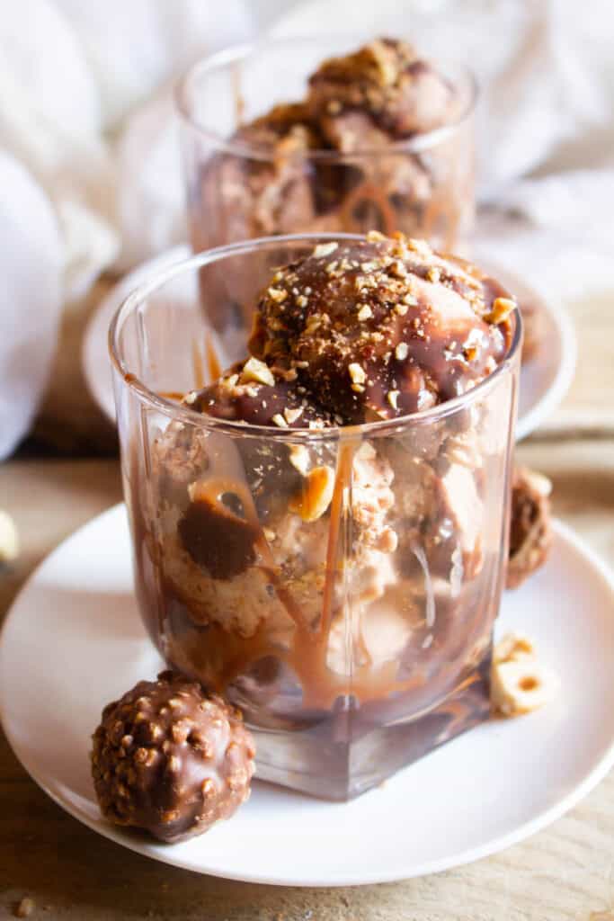 Ferrero Rocher Ice Cream in glass cup topped with chocolate.
