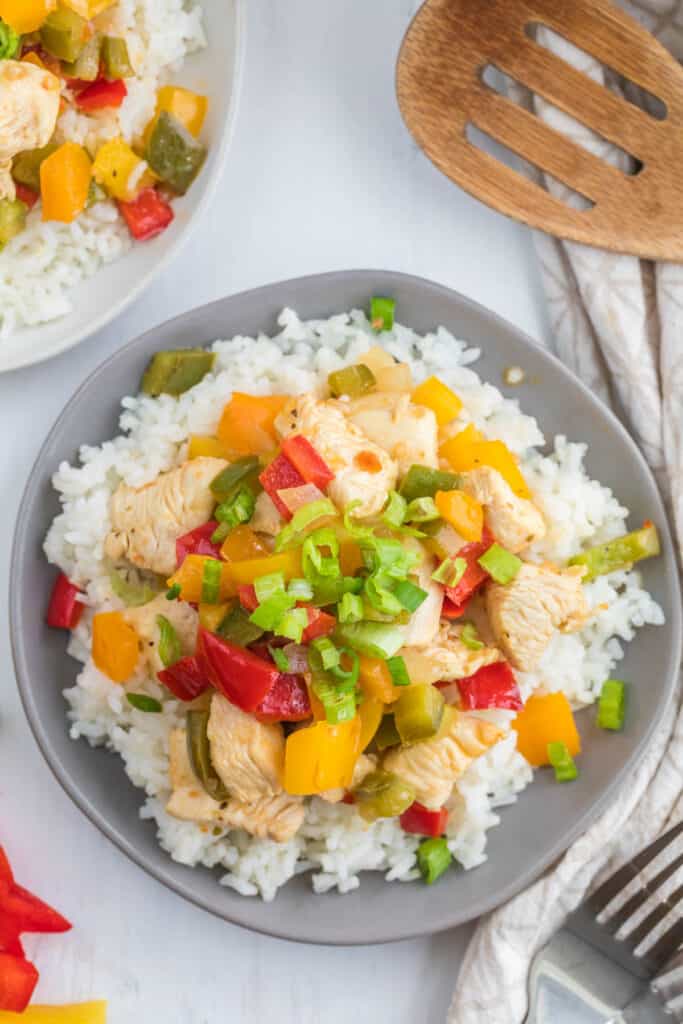 stir fry cooked on gray plate over rice.