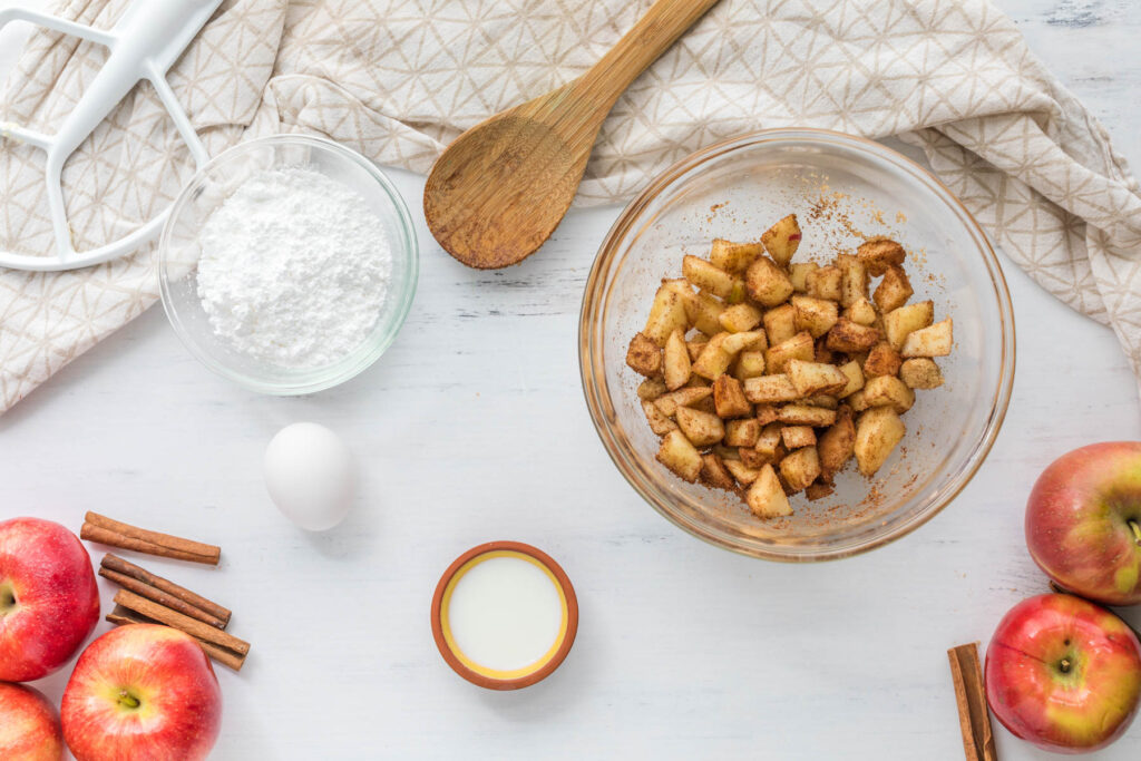 apples mixed in bowl with cinnamon.