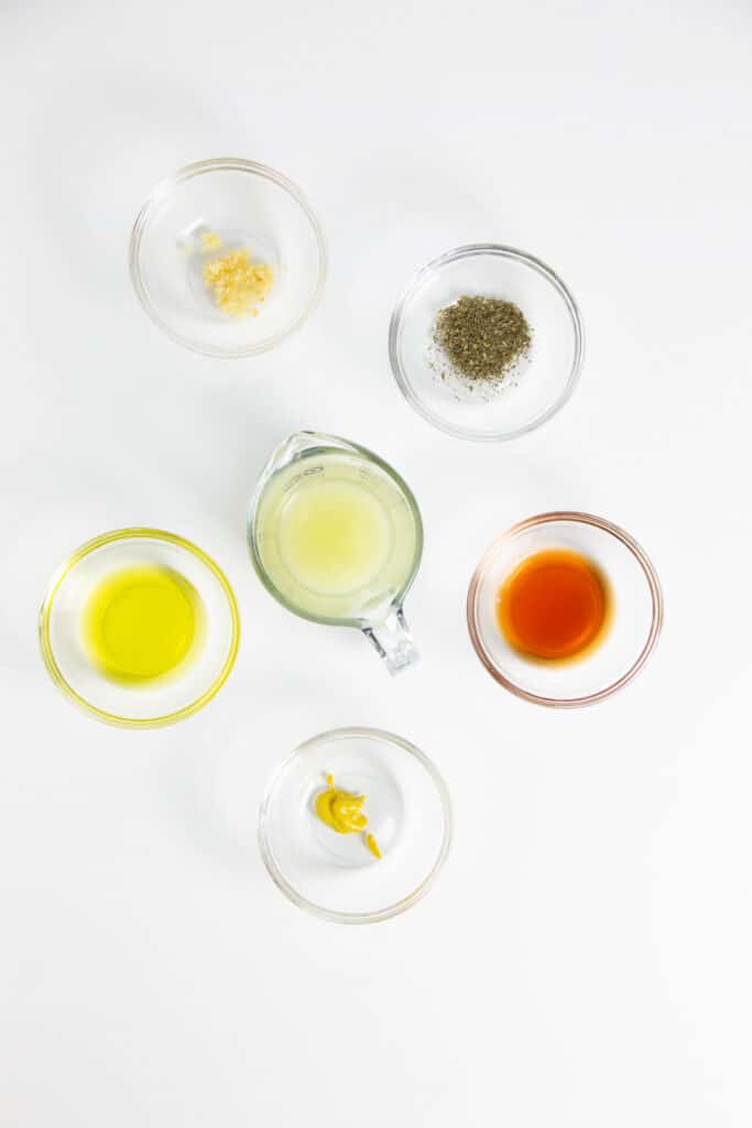 Greek Pasta Salad ingredients in glass bowls.