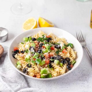 Greek Pasta Salad topped with cheese.