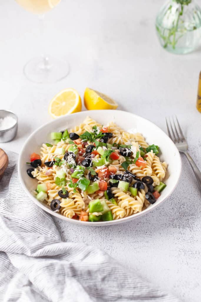 Greek Pasta Salad topped with cheese.