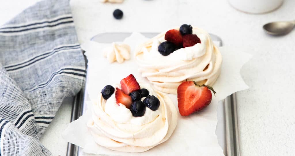 Mini Berry Meringue with fresh berries on top.