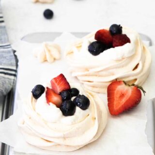 Mini Berry Meringue with fresh berries on top.