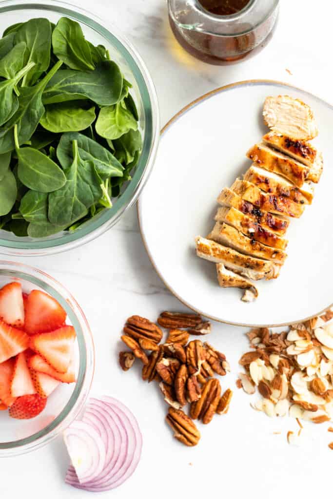 Strawberry Chicken Spinach Salad ingredients in bowls.