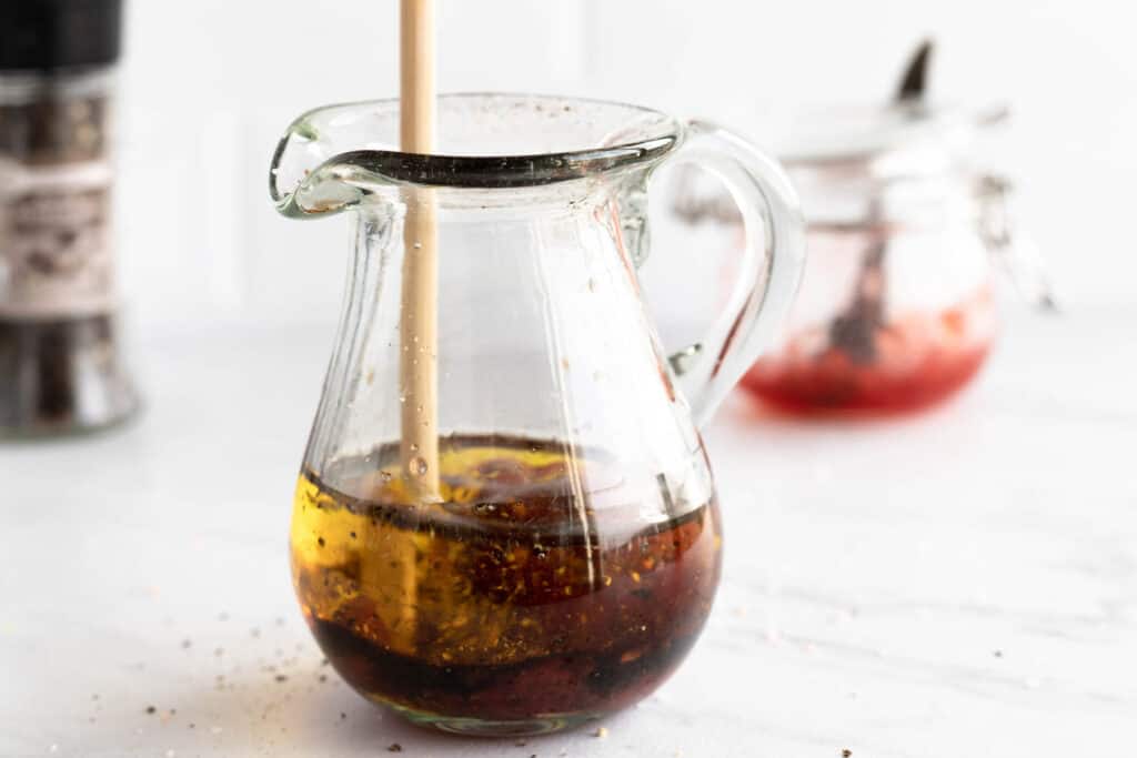 stirring dressing in glass bowl.