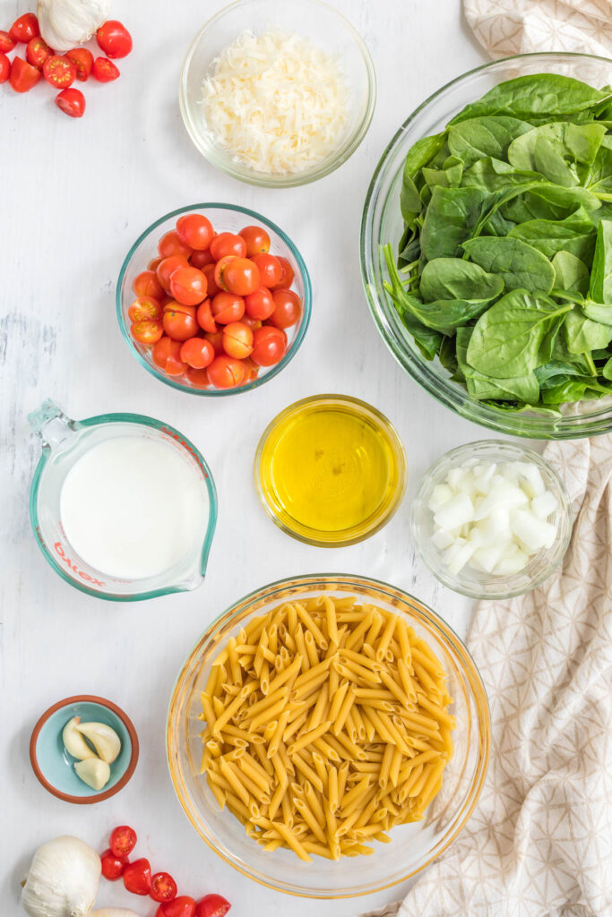 Creamy Tomato Spinach Pasta ingredients in bowls.