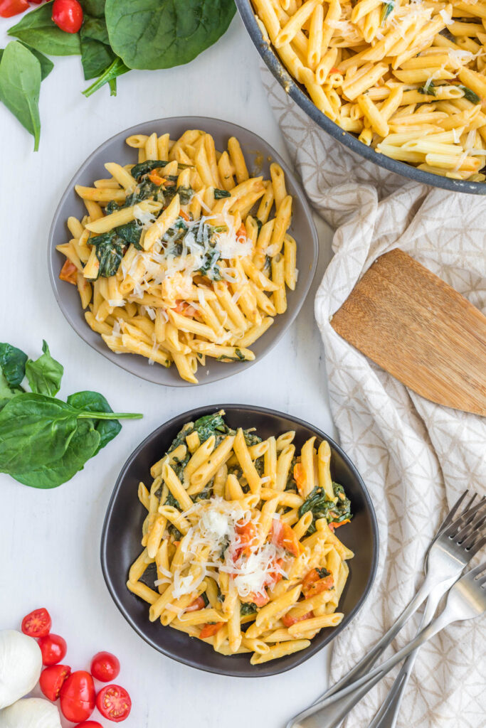 Creamy Tomato Spinach Pasta on plates.