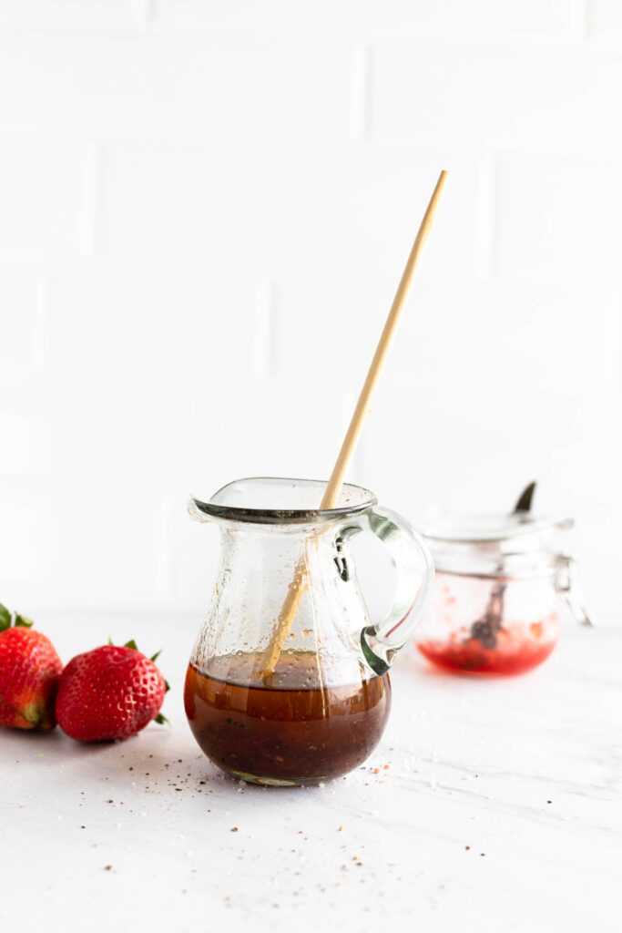 dressing mixing in glass pitcher.